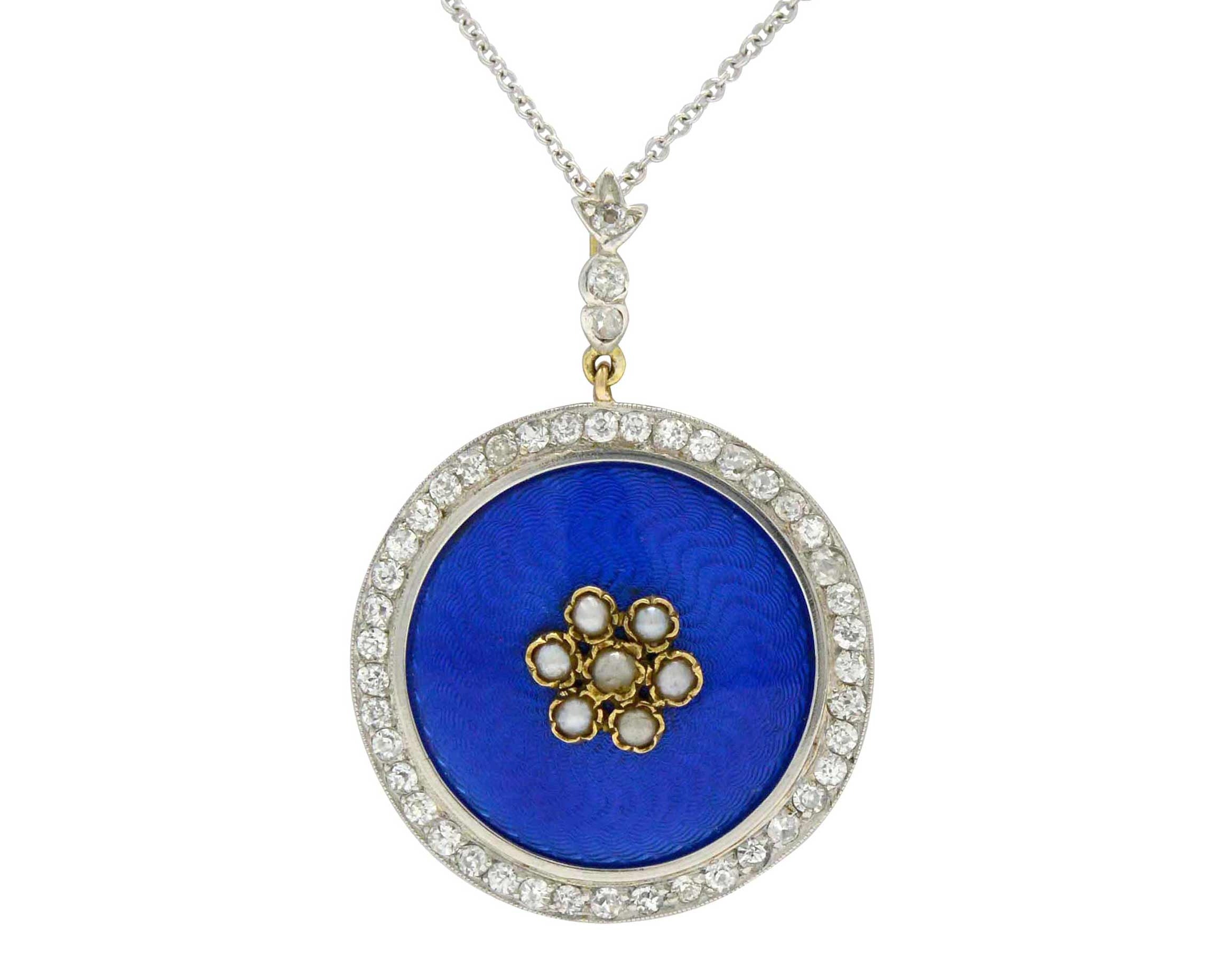This blue enamel pendant has a motif of dainty seed pearls and blue enamel.