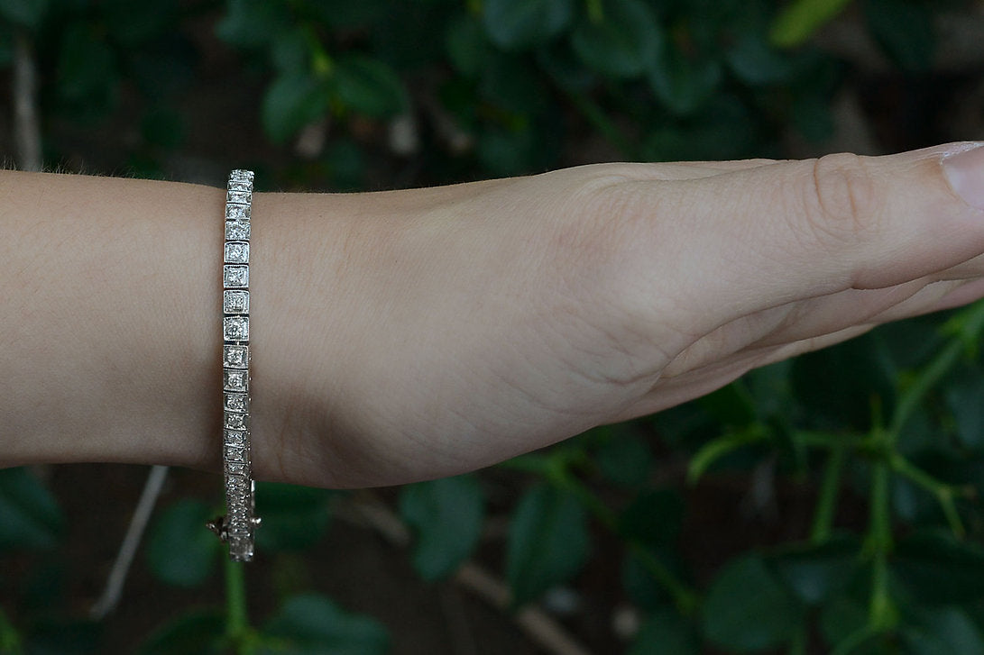 Two carats of diamonds are set in a straight line in this white gold tennis bracelet.