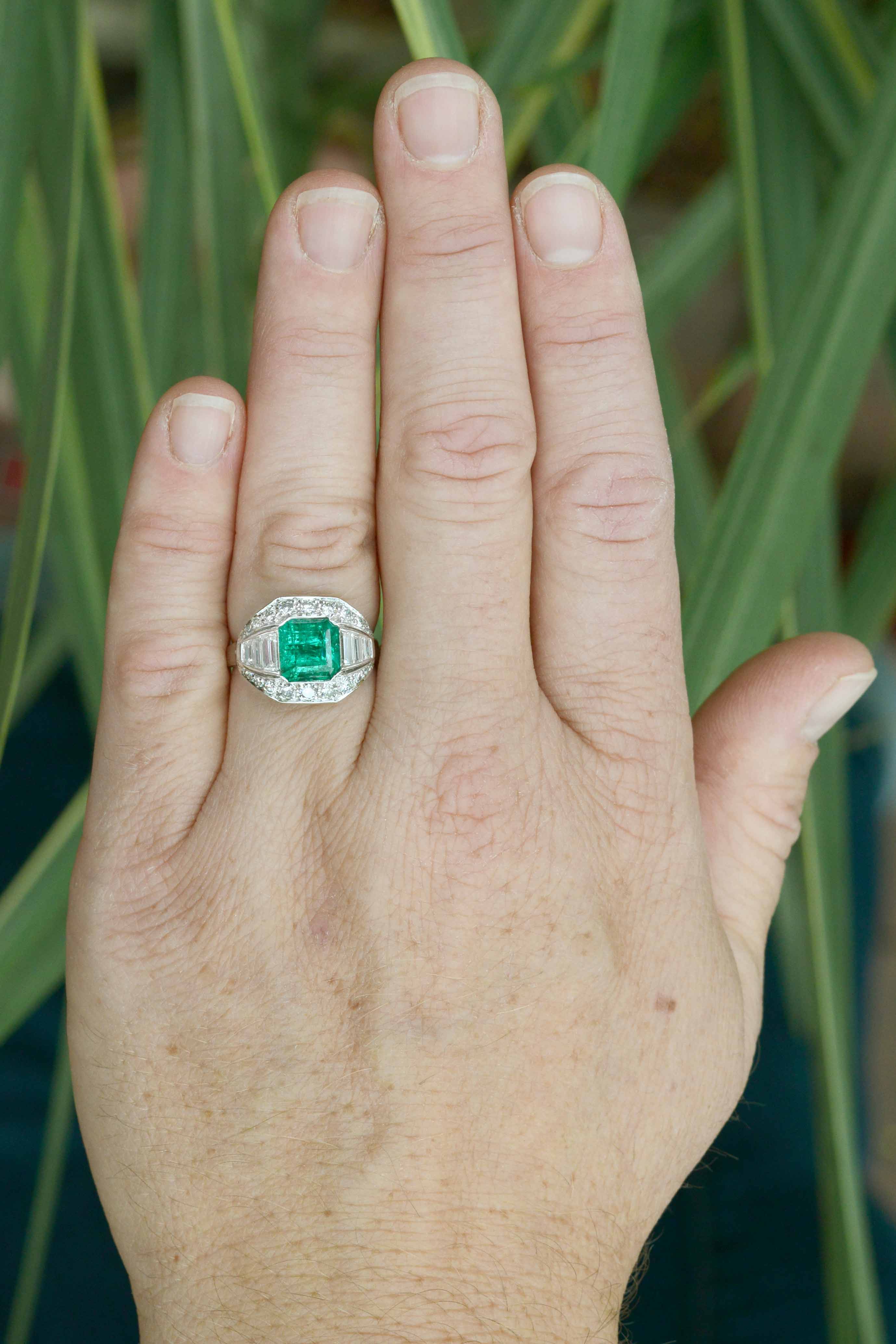 An Art Deco statement ring with a square emerald, accented by diamonds.