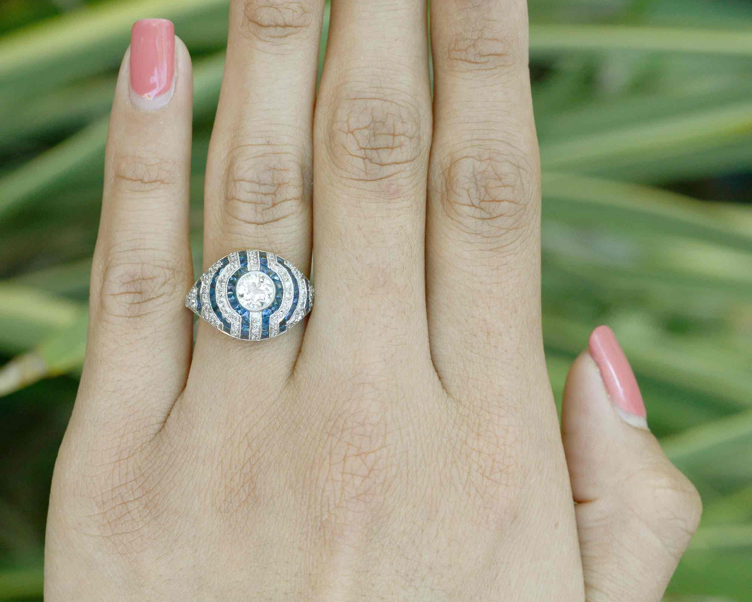 The lines of diamonds and blue sapphires make a unique pattern in this engagement ring.