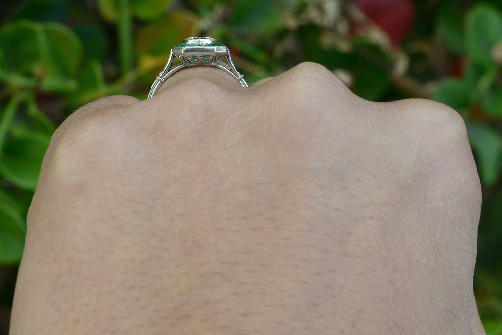 An Art Deco style diamonds emeralds engagement ring.