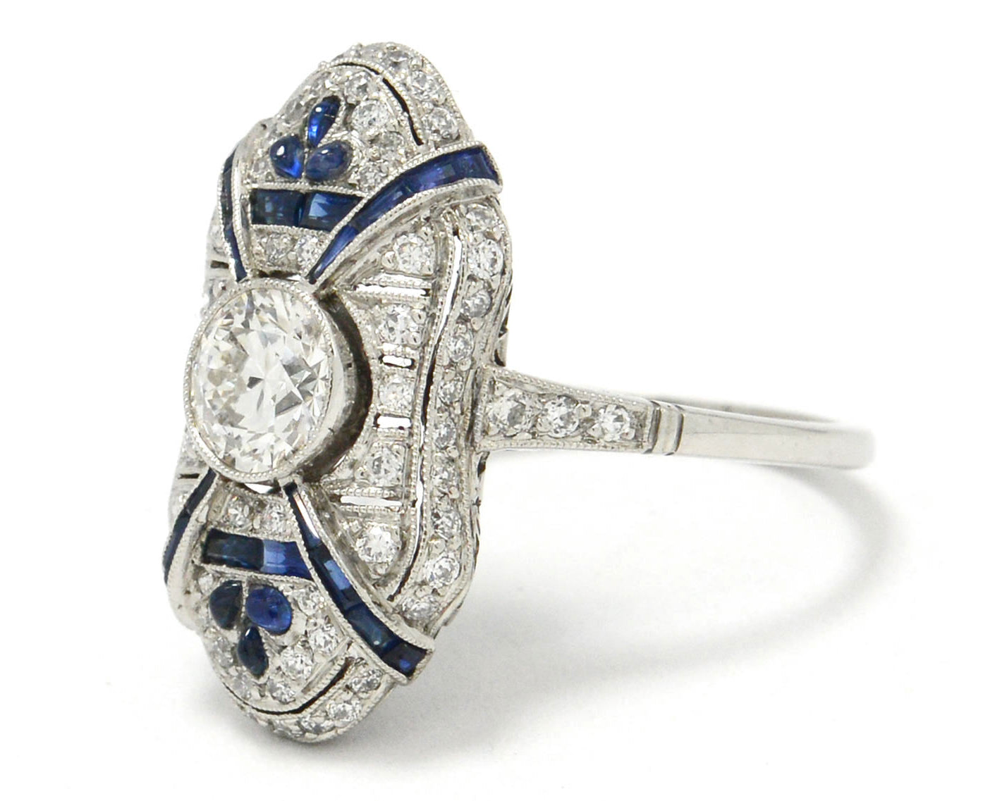 The 1 carat round diamond is accented by blue sapphires.
