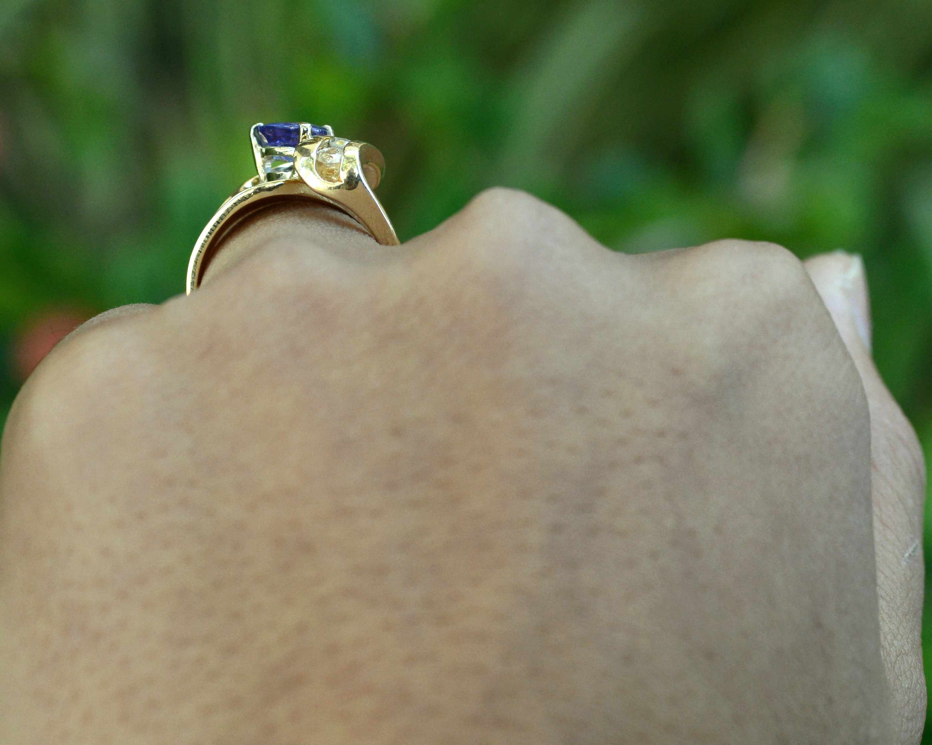A triangle shaped tanzanite, set in a 14k gold diamonds cocktail ring.