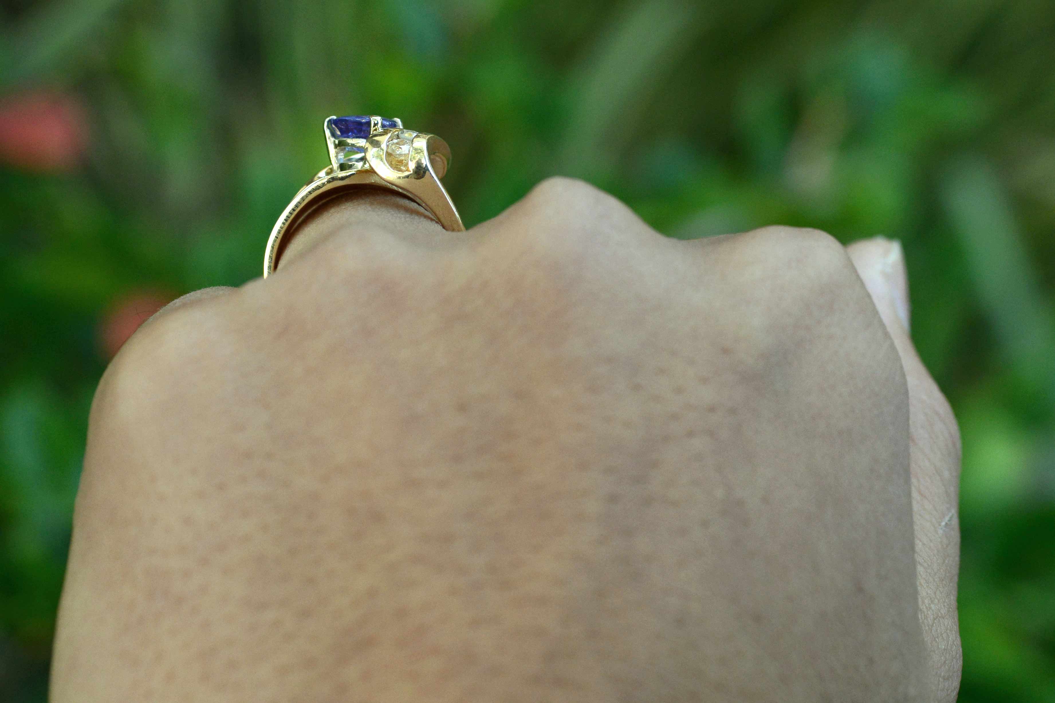A triangle shaped tanzanite, set in a 14k gold diamonds cocktail ring.