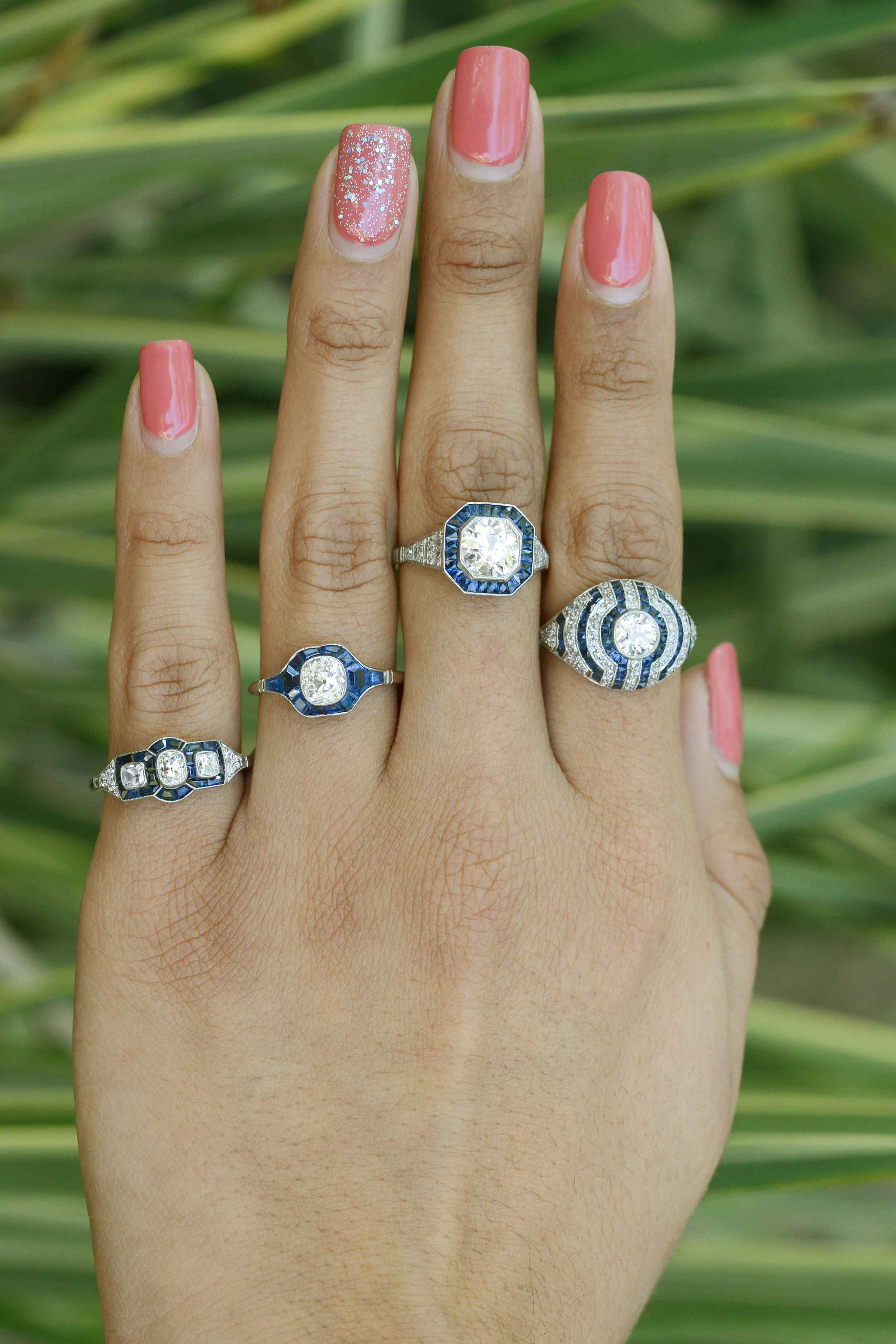 Some of our diamond and blue sapphire platinum cluster engagement rings.