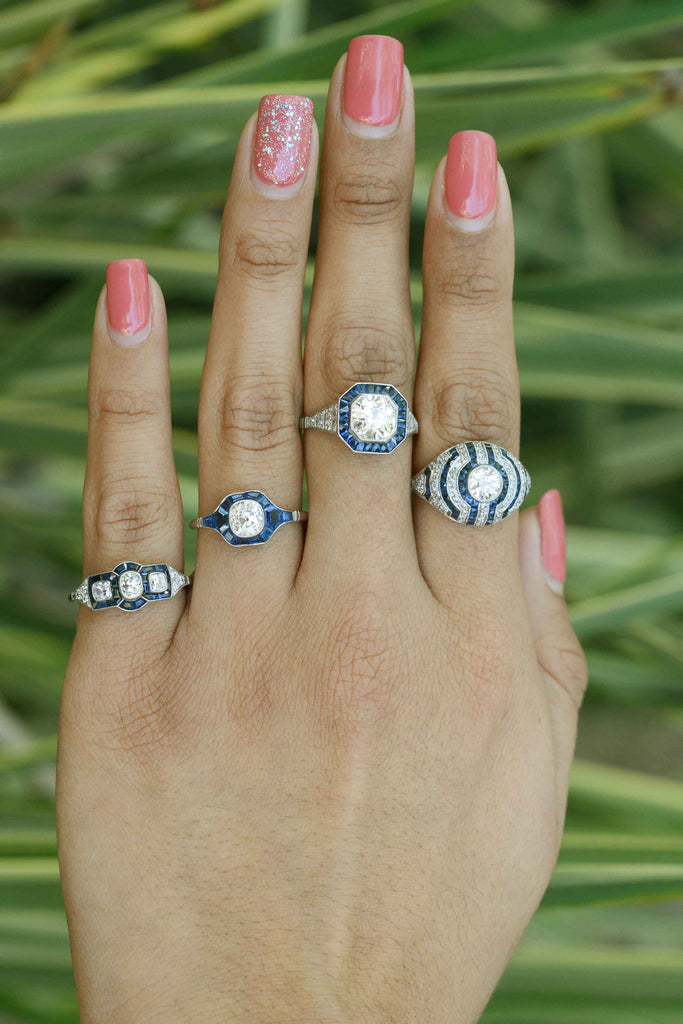 Some of our diamond and blue sapphire platinum cluster engagement rings.