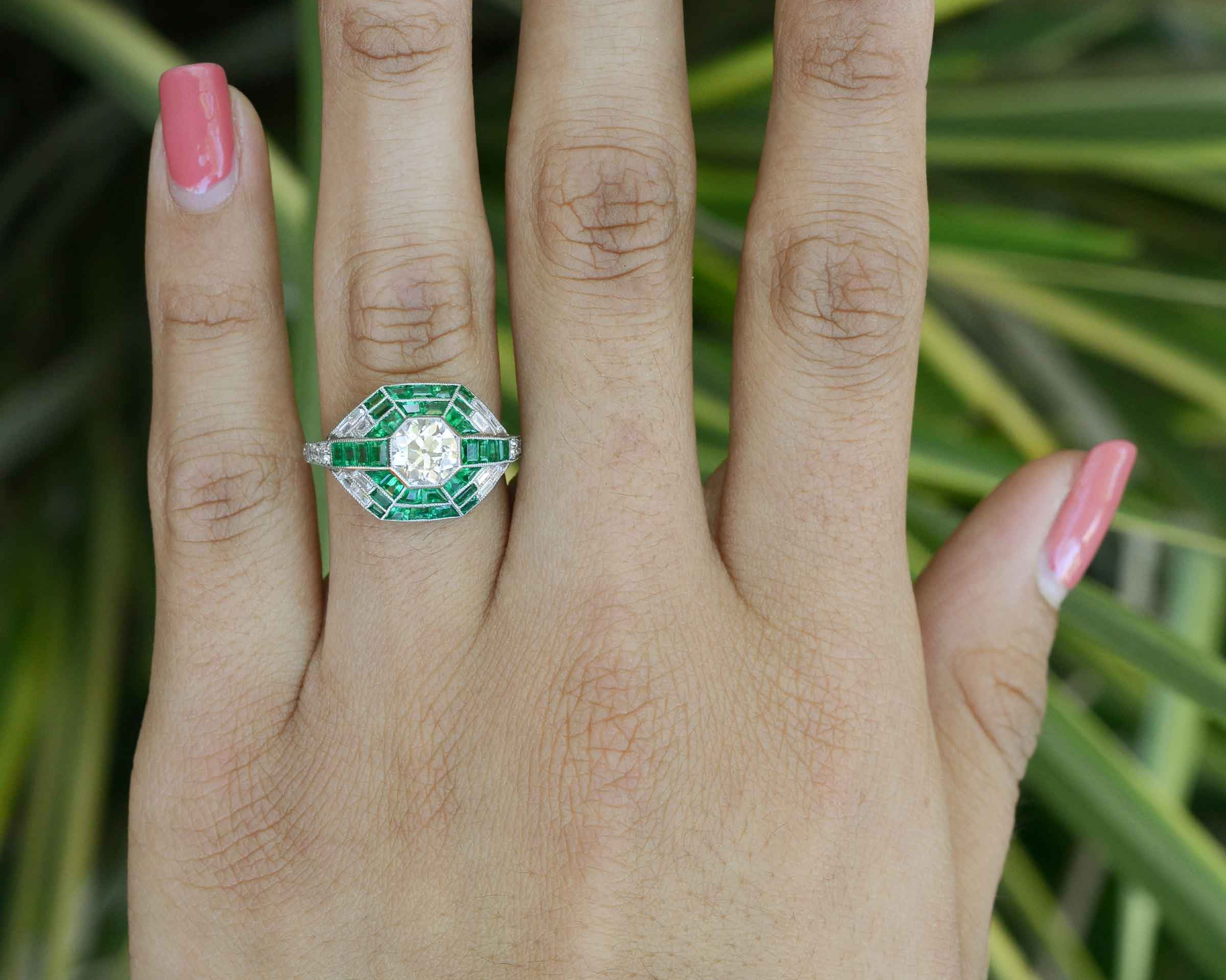A size 6 old mine diamond engagement ring with French & calibre cut emeralds.