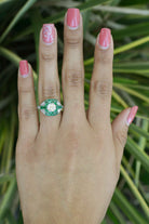 A size 6 old mine diamond engagement ring with French & calibre cut emeralds.