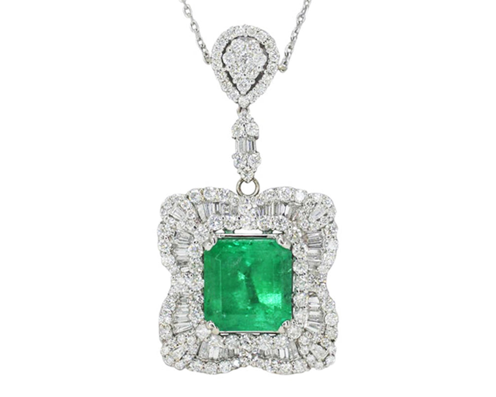 A contemporary emerald & diamond ballerina setting pendant necklace.