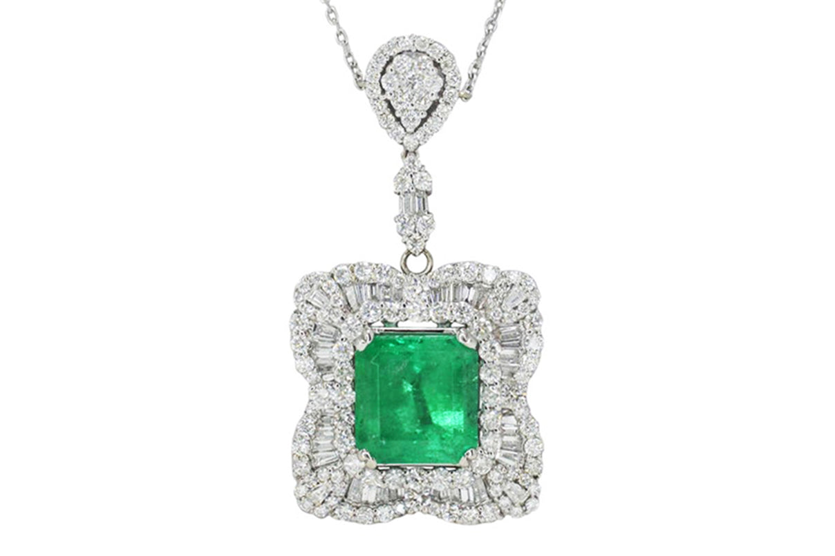 A contemporary emerald & diamond ballerina setting pendant necklace.