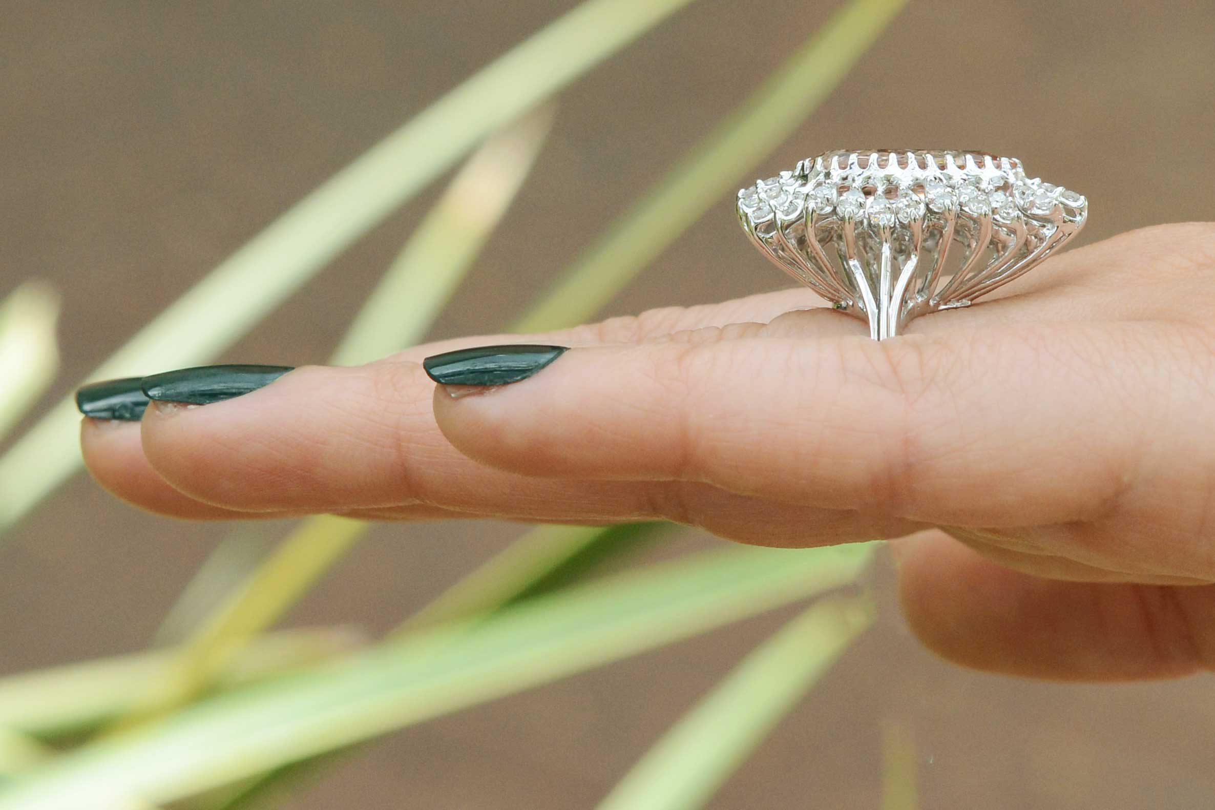 A morganite ballerina ring design encircled by round diamonds.