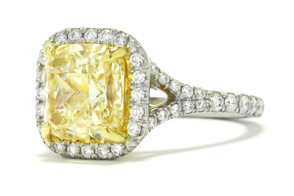 This excellently proportioned cushion cut yellow diamond radiates with a captivating brilliance.