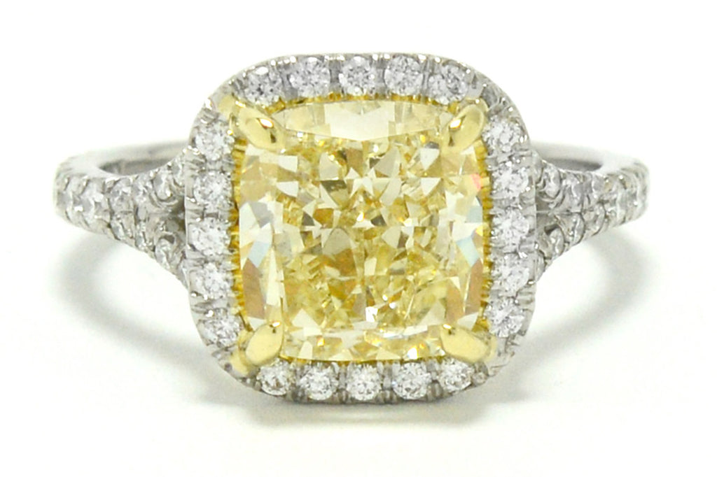 A cushion modified brilliant cut 3 carat yellow canary diamond target ring.