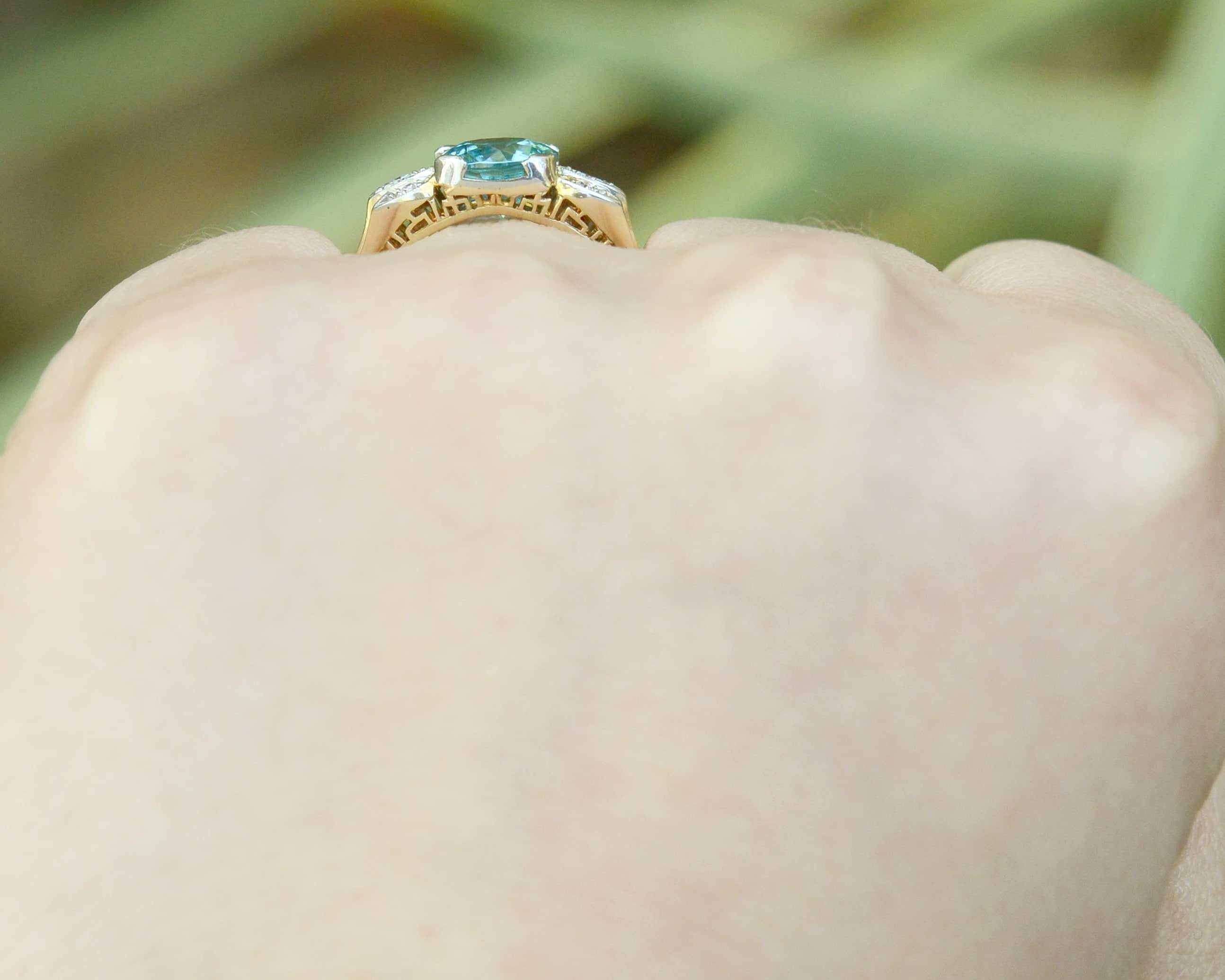 A neon blue zircon with great clarity set in a bridal ring with diamonds.